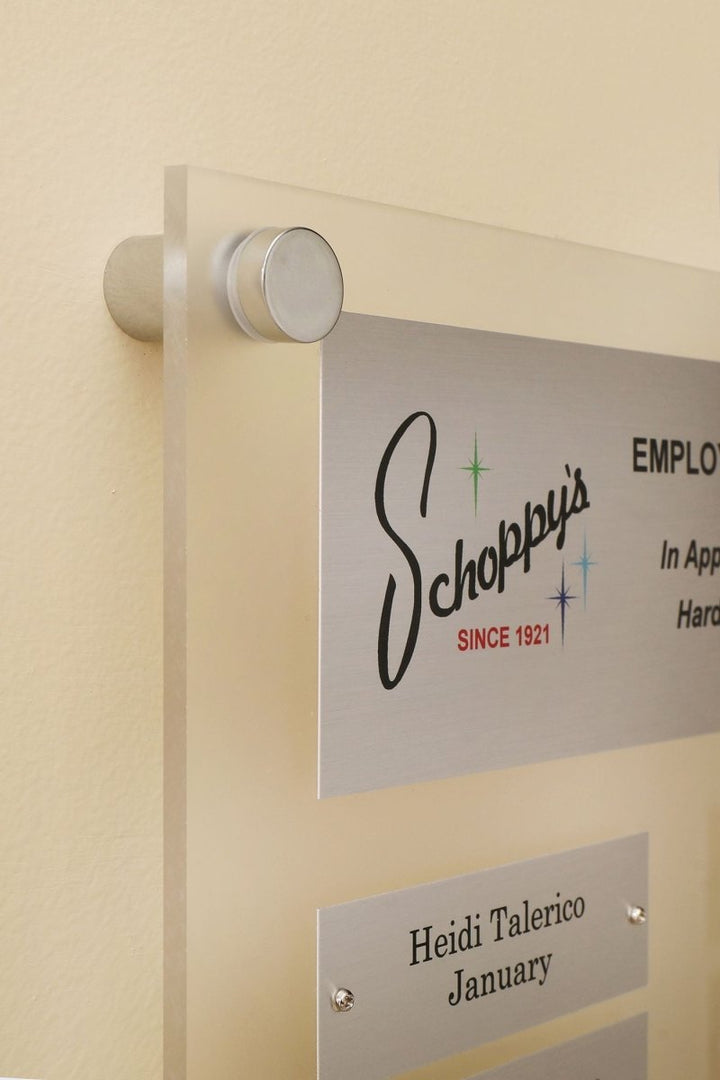 Close up of  12 by 15 inch frosted acrylic perpetual plaque with 12 Individual Silver Aluminum engraving plates 