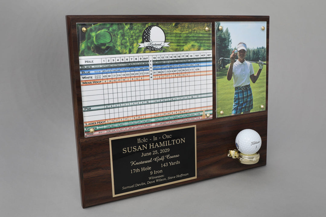 A wooden plaque featuring a photo of a golfer, a golf scorecard, and a engraved plate with text recognizing a hole in one achievement.
