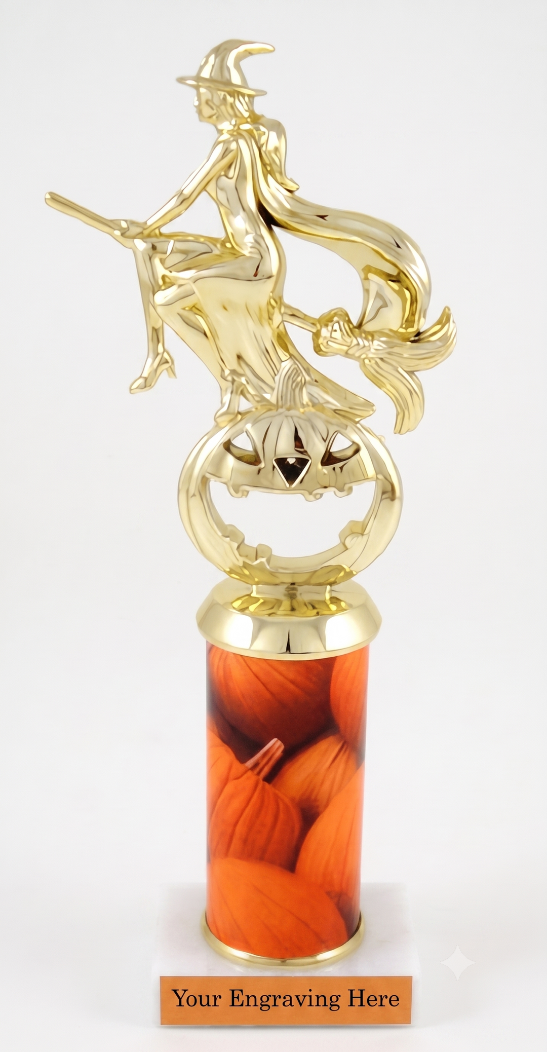 A gold-finished Halloween trophy featuring a witch riding a broomstick atop a carved jack-o&