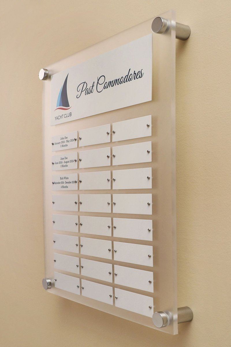 Side View of a 12 by 15 inch Frosted Acrylic plaque with Header Plate, Logo and 24 Individual White name plates for recognizing employees mounted on a wall.
