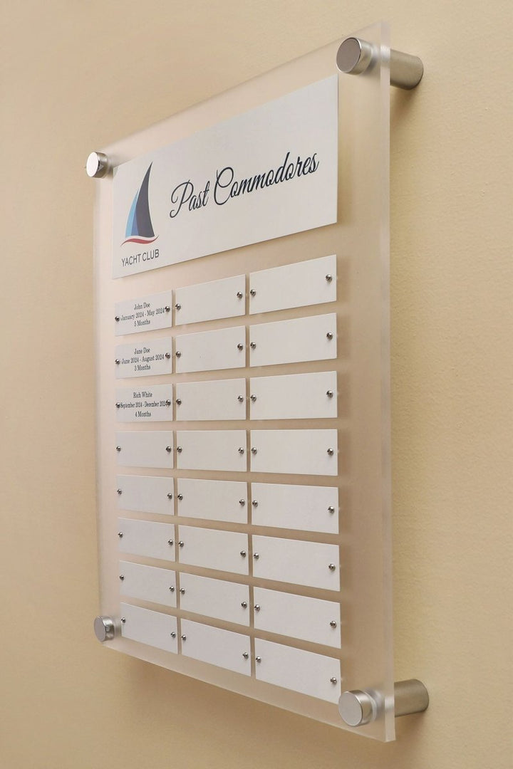 Side View of a 12 by 15 inch Frosted Acrylic plaque with Header Plate, Logo and 24 Individual White name plates for recognizing employees mounted on a wall.